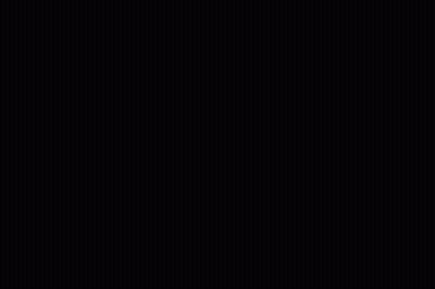Man In Striped Shirt Holding Microphone In Front Of Empty Seats GIF