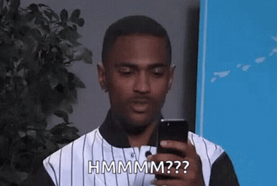 Man In Striped Shirt Holding Phone And Making Funny Face GIF