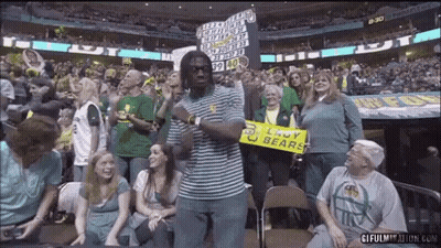 Man In Striped Shirt Holding Sign Saying Lady Bears GIF
