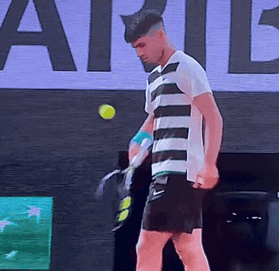 Man In Striped Shirt Holding Tennis Racquet GIF