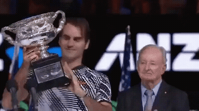 Man In Striped Shirt Holding Trophy GIF