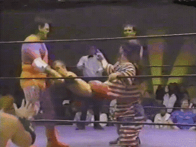 Man In Striped Shirt In Boxing Ring GIF
