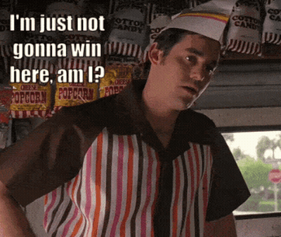 Man In Striped Shirt In Front Of Cotton Candy Bags GIF