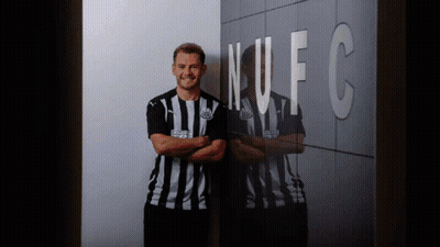 Man In Striped Shirt In Front Of NFC Wall GIF