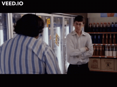 Man In Striped Shirt In Front Of Refrigerator Veed.io GIF