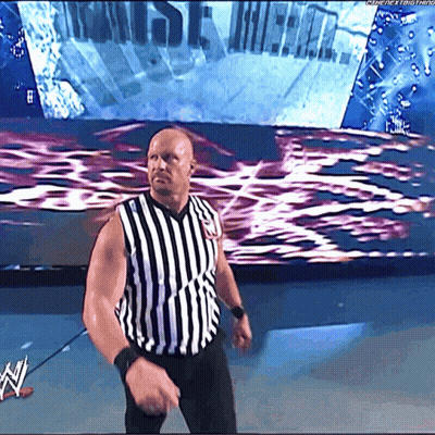Man In Striped Shirt In Front Of WWE Screen GIF