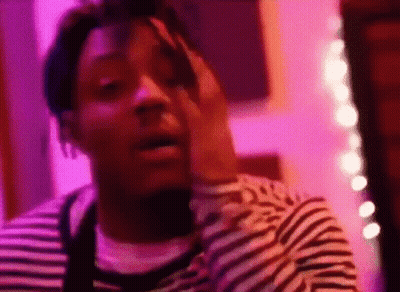 Man In Striped Shirt In Purple Room GIF