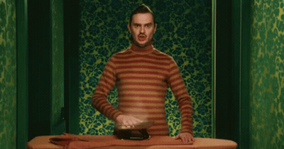 Man In Striped Shirt Ironing GIF