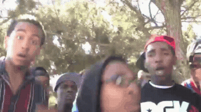 Man In Striped Shirt Looking At Camera GIF