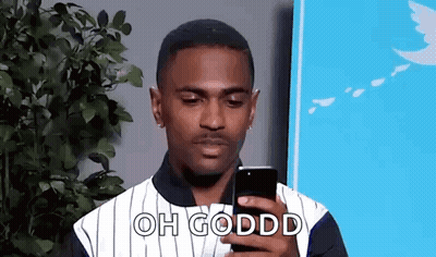 Man In Striped Shirt Looking At Cell Phone GIF