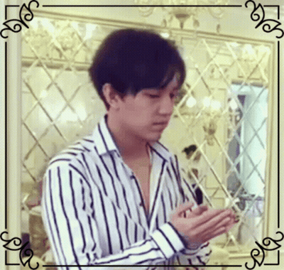 Man In Striped Shirt Looking At Phone GIF