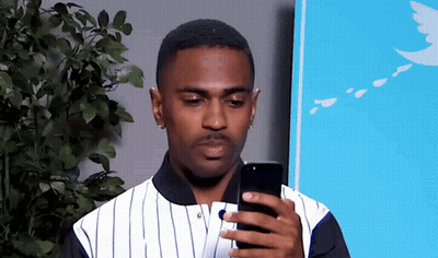 Man In Striped Shirt Looking At Phone GIF