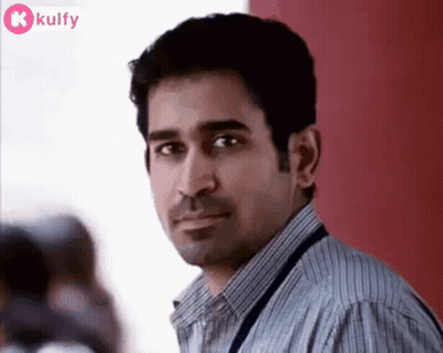 Man In Striped Shirt Looking Serious GIF