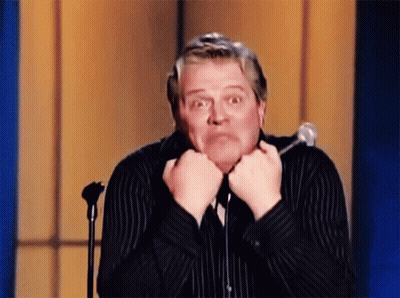 Man In Striped Shirt Making Funny Face At Microphone GIF