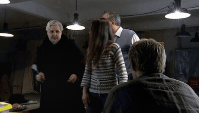 Man In Striped Shirt Making Funny Face Saying Here I Am GIF