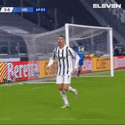 Man In Striped Shirt Running Towards Soccer Goal GIF