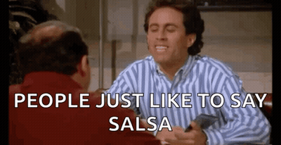 Man In Striped Shirt Sitting At Table With Man In Red Jacket GIF