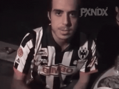 Man In Striped Shirt Sitting At Table With Plate Of Food GIF
