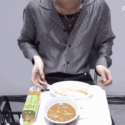 Man In Striped Shirt Sitting At Table With Soup And Tea GIF