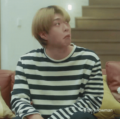 Man In Striped Shirt Sitting On Couch GIF