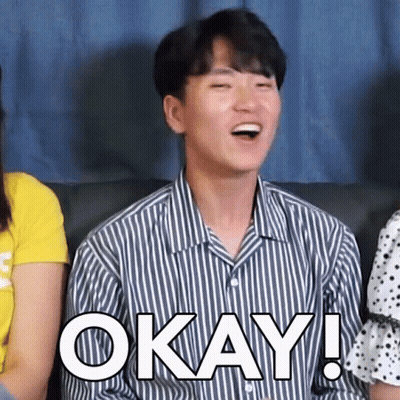 Man In Striped Shirt Sitting On Couch Saying Okay GIF