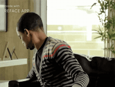 Man In Striped Shirt Sitting On Couch With Reface App GIF