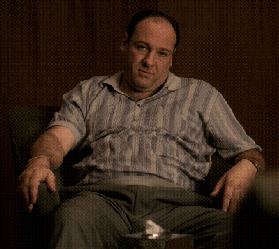 Man In Striped Shirt Sitting GIF