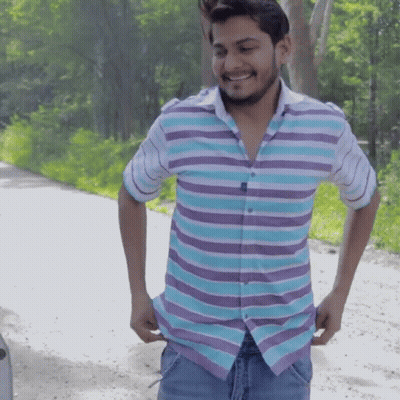 Man In Striped Shirt Smiling Holding Pockets GIF