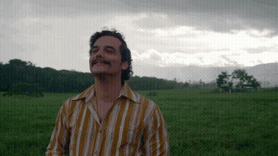 Man In Striped Shirt Standing In Field GIF