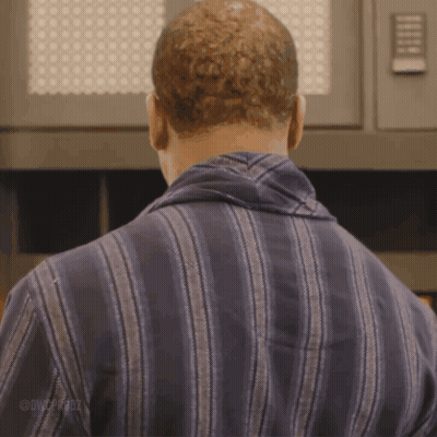 Man In Striped Shirt Standing In Front Of Microwave GIF