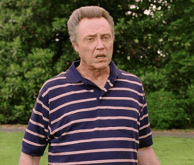 Man In Striped Shirt Standing In Park GIF
