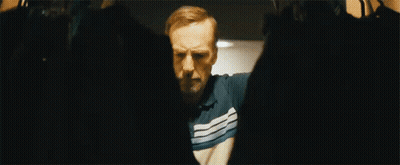 Man In Striped Shirt Standing With Arms Outstretched GIF