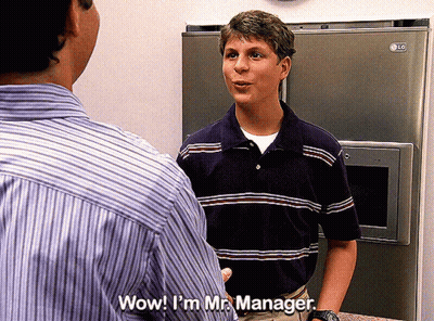 Man In Striped Shirt Talking To Another Man In Front Of LG Refrigerator GIF
