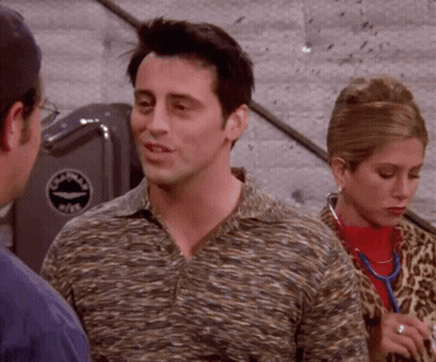 Man In Striped Shirt Talking To Woman In Leopard Print Coat GIF