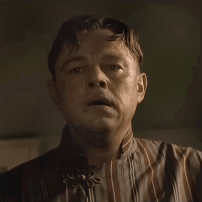 Man In Striped Shirt With Flower Collar GIF