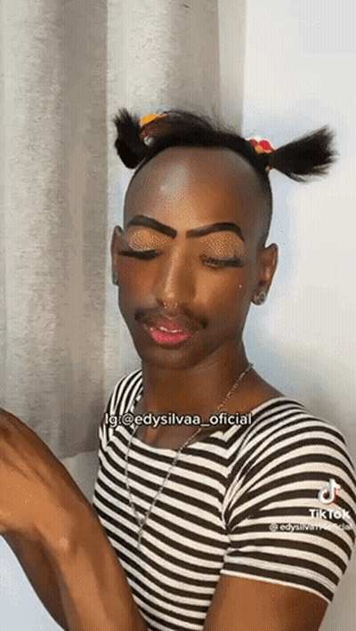 Man In Striped Shirt With Pigtail And Makeup GIF