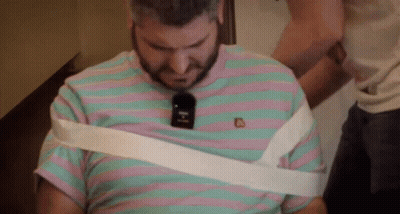 Man in Striped Shirt Wrapped in White Tape