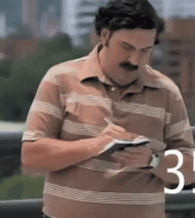 Man In Striped Shirt Writing GIF