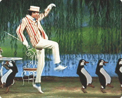 Man In Striped Suit Jumping And Dancing With Penguins GIF