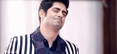 Man In Striped Suit Making Funny Face GIF