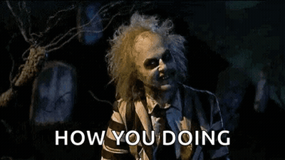 Man In Striped Suit Saying How You Doing At Cemetery GIF