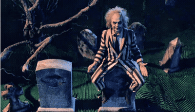 Man In Striped Suit Sitting On Grave GIF