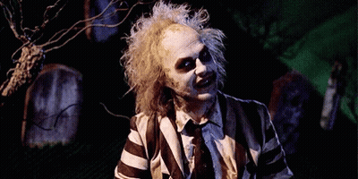 Man In Striped Suit Smiling Holding Knife GIF