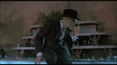Man In Striped Suit Standing In Front Of Cake GIF