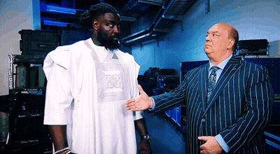 Man In Striped Suit Talks To Man In White Shirt GIF