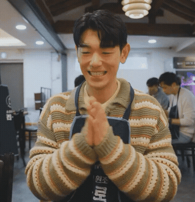 Man In Striped Sweater And Apron With Foreign Language GIF