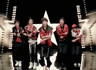 Man In Striped Sweater And Pearls Making Heart Shape With Hands GIF
