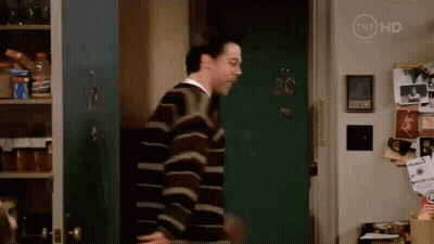 Man In Striped Sweater In Front Of Door Number 20 GIF