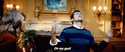 Man In Striped Sweater Saying Oh My God To Woman GIF
