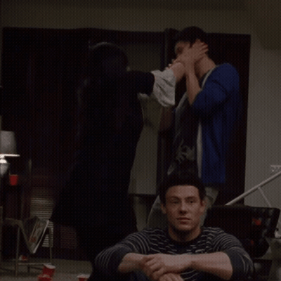 Man In Striped Sweater Sitting On Couch GIF